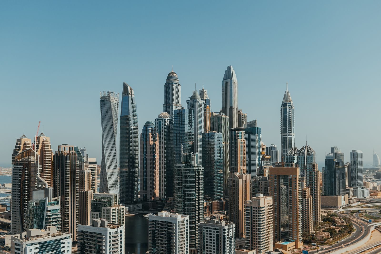 Dubai Marina towers under a blue sky